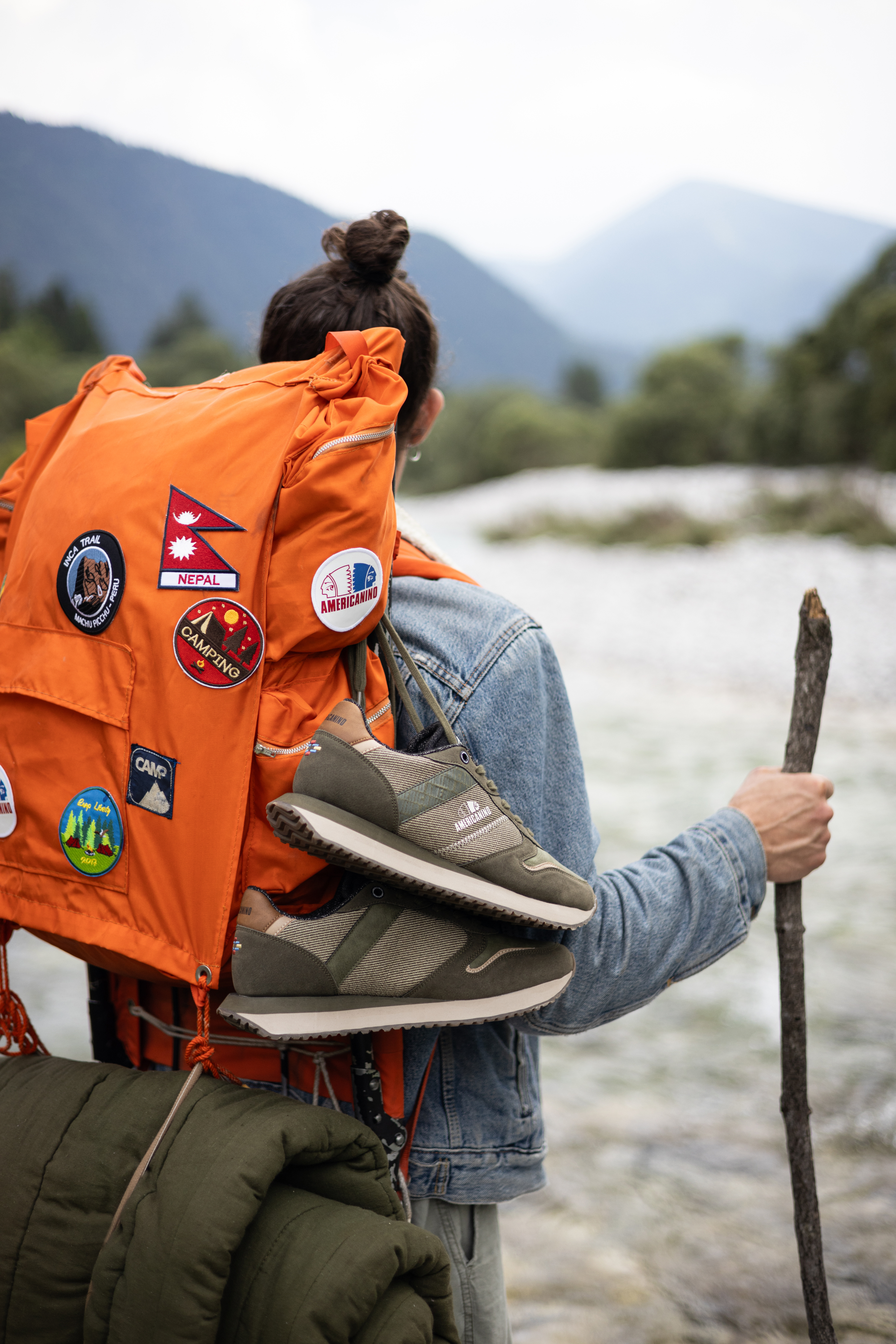 young woman at the lake with an orange backpack and Americanino Original shoes